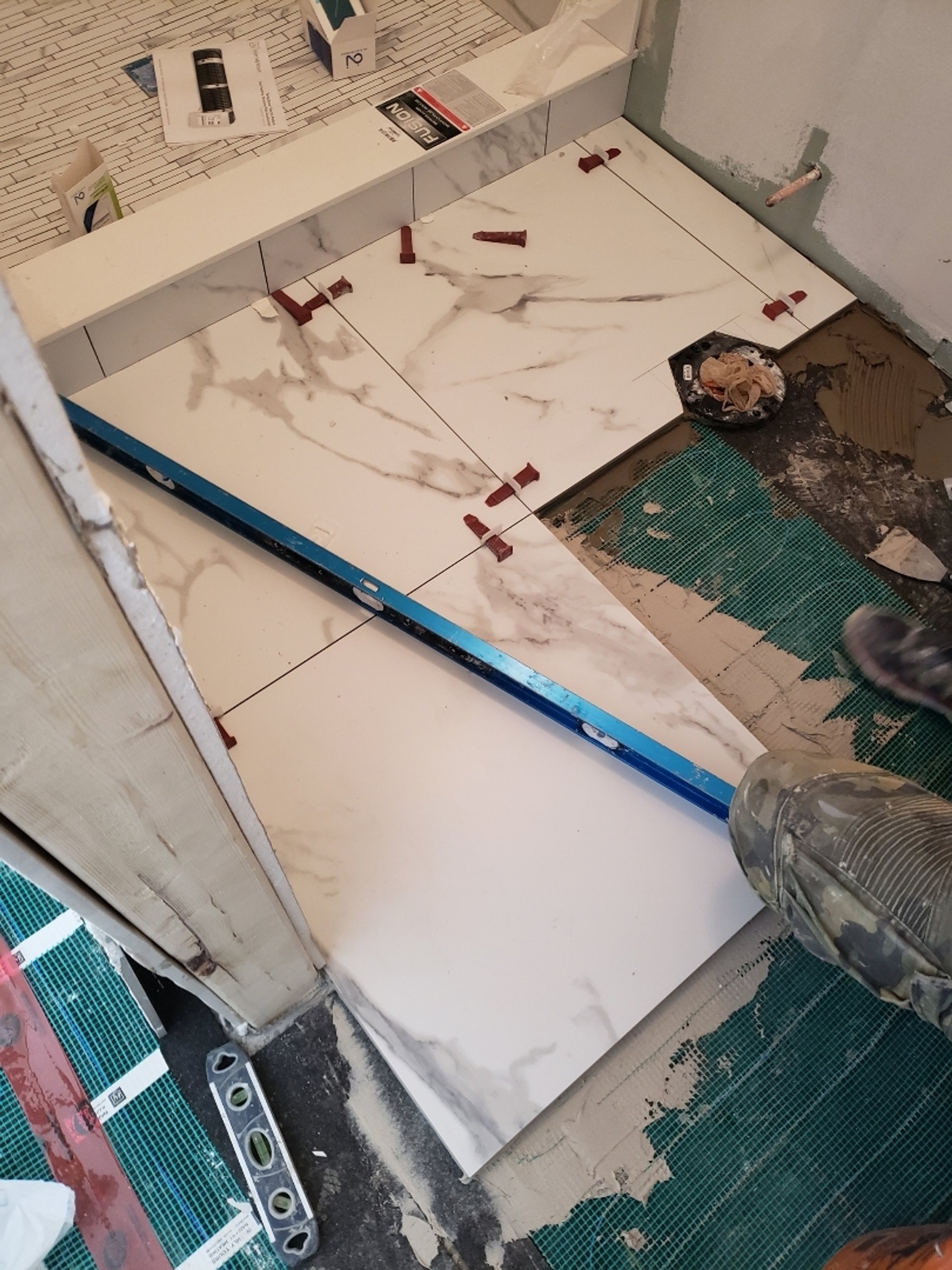 Heated Tile Installation for remodeled basement bathroom laying tile