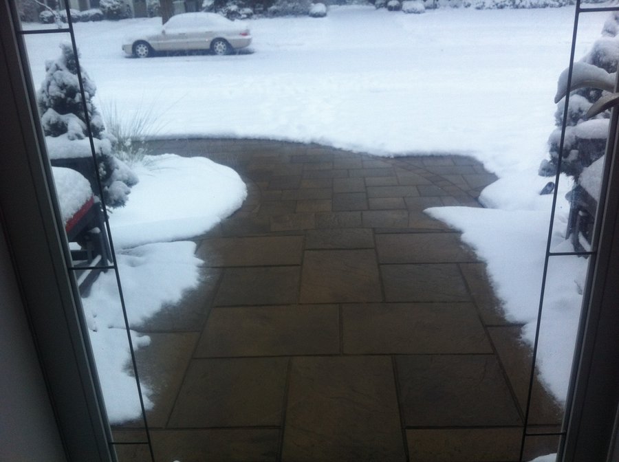 Heated walkway and porch with pavers during wintertime