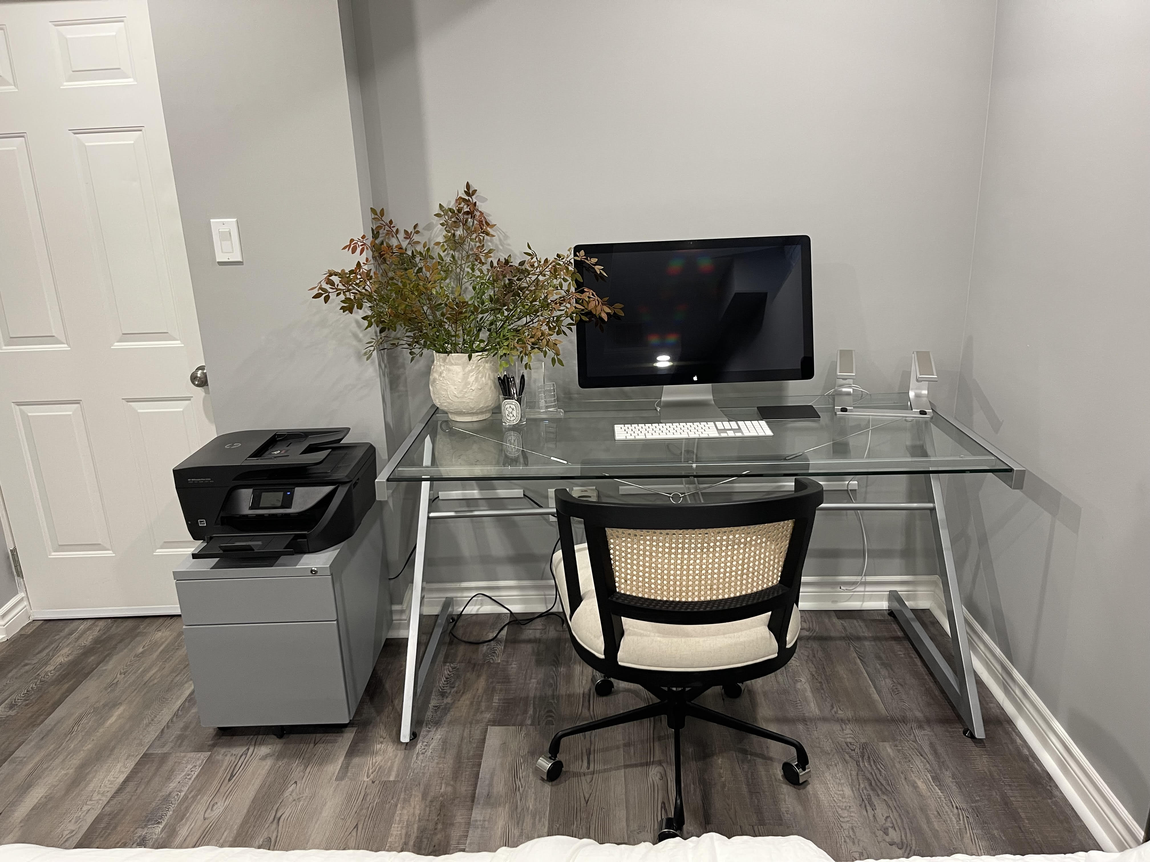 A home office nook featuring electric radiant floor heating installed beneath dark wood-grain flooring.