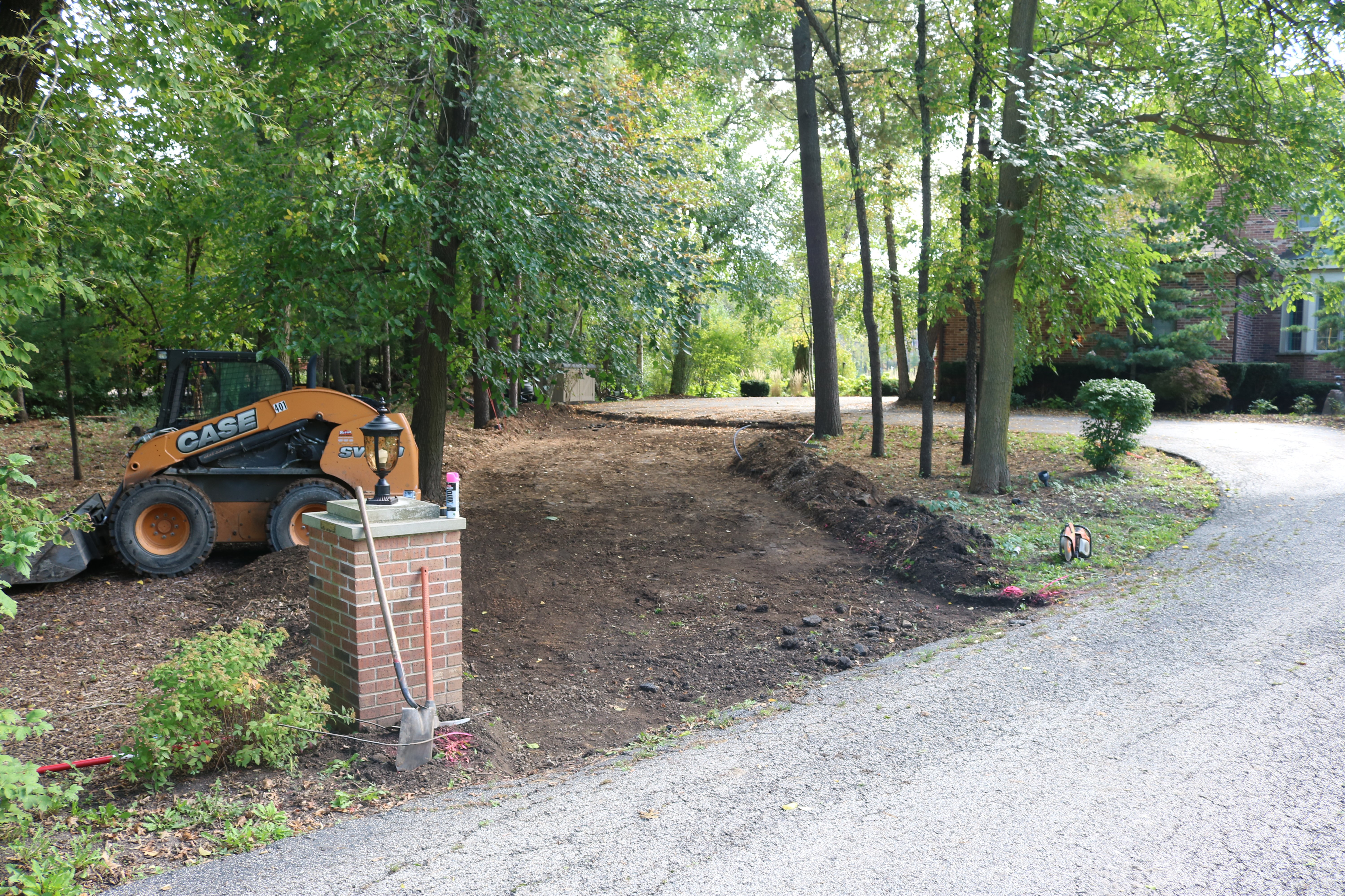 Home with driveway expansion in progress