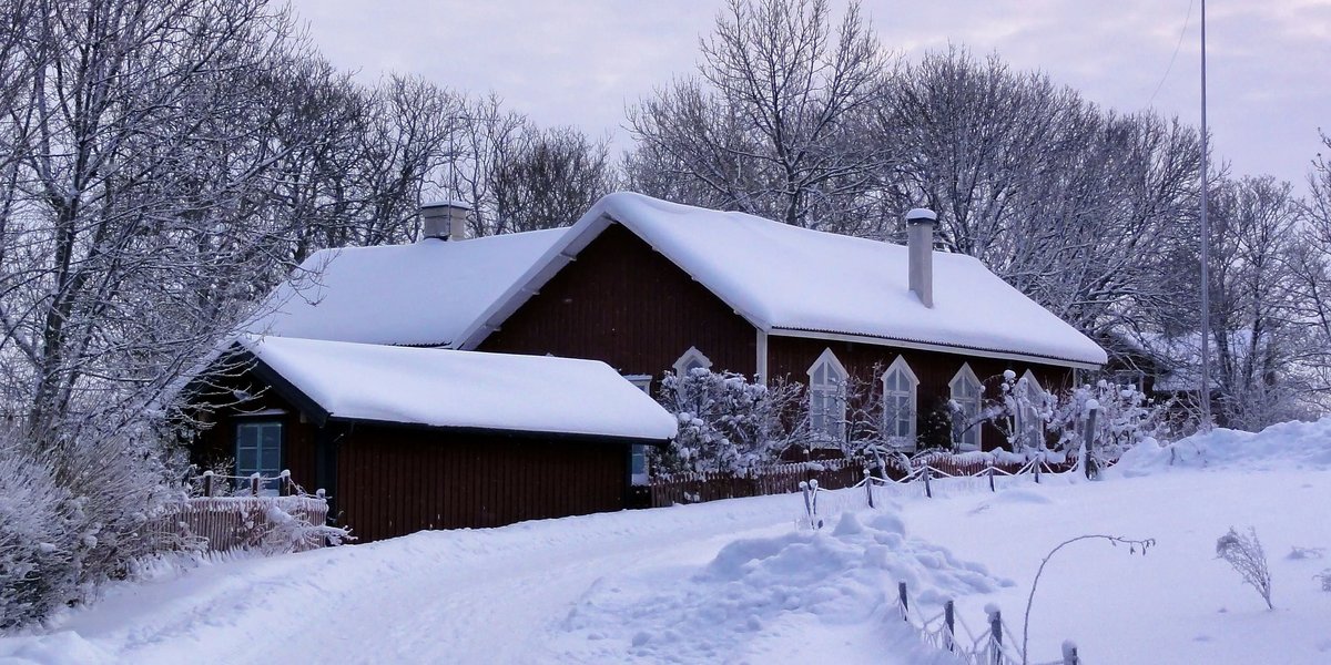 House cover by snow in winter landscape
