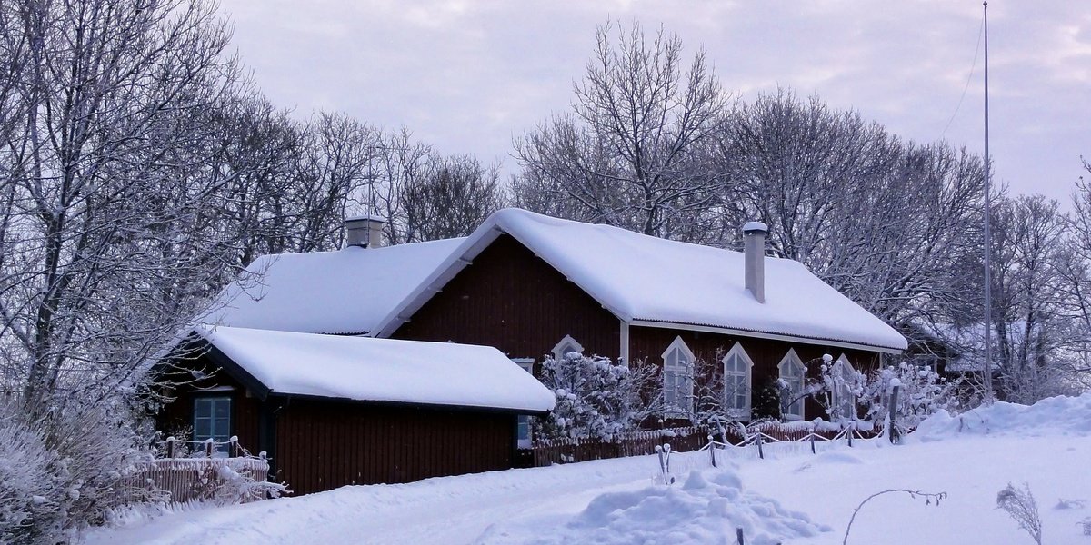 House cover by snow in winter landscape