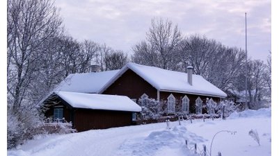 House cover by snow in winter landscape