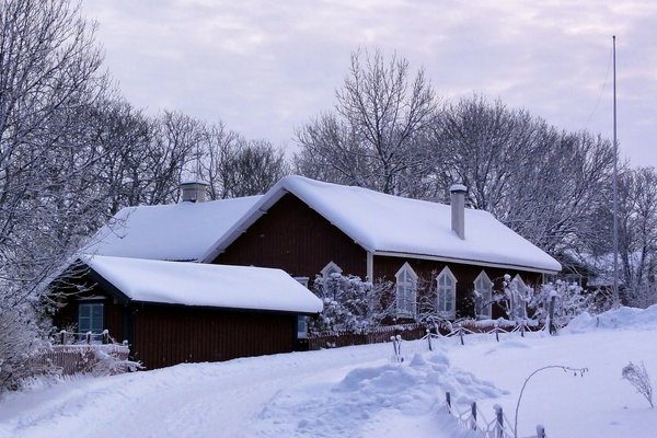 House cover by snow in winter landscape