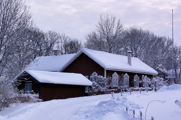 House cover by snow in winter landscape