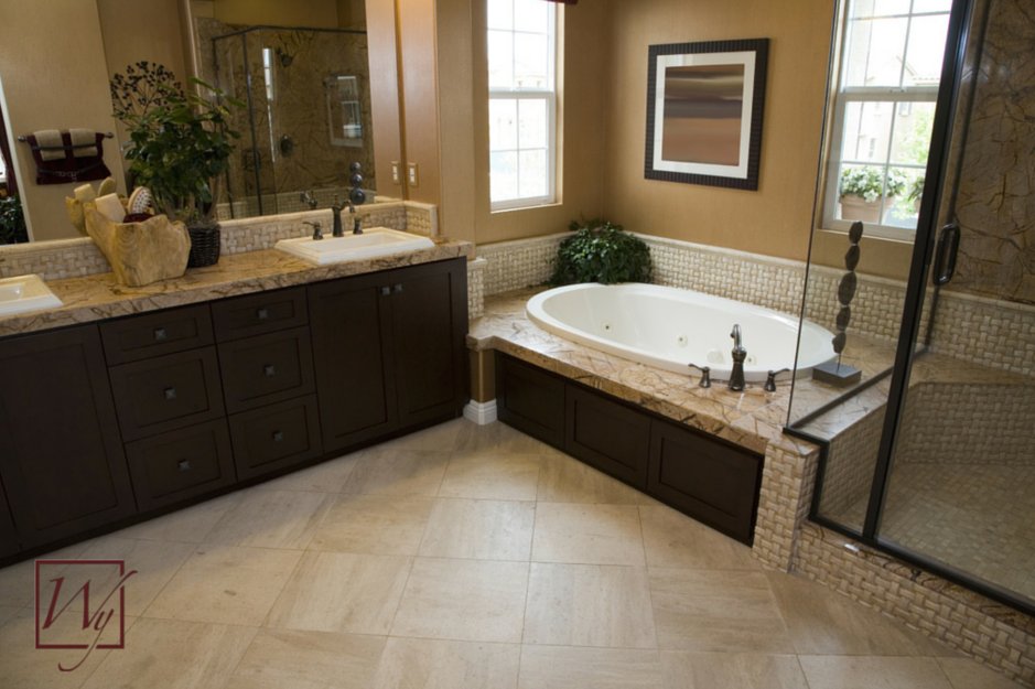 A finished master bathroom featuring TempZone electric radiant floor heating installed beneath diagonally laid beige tile flooring.