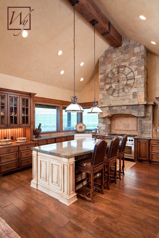 A rustic kitchen with hardwood flooring featuring an electric radiant floor heating system beneath the wood planks.