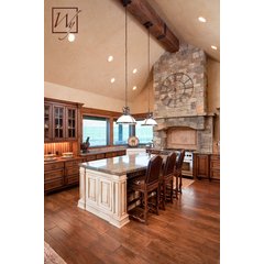 A rustic kitchen with hardwood flooring featuring an electric radiant floor heating system beneath the wood planks.