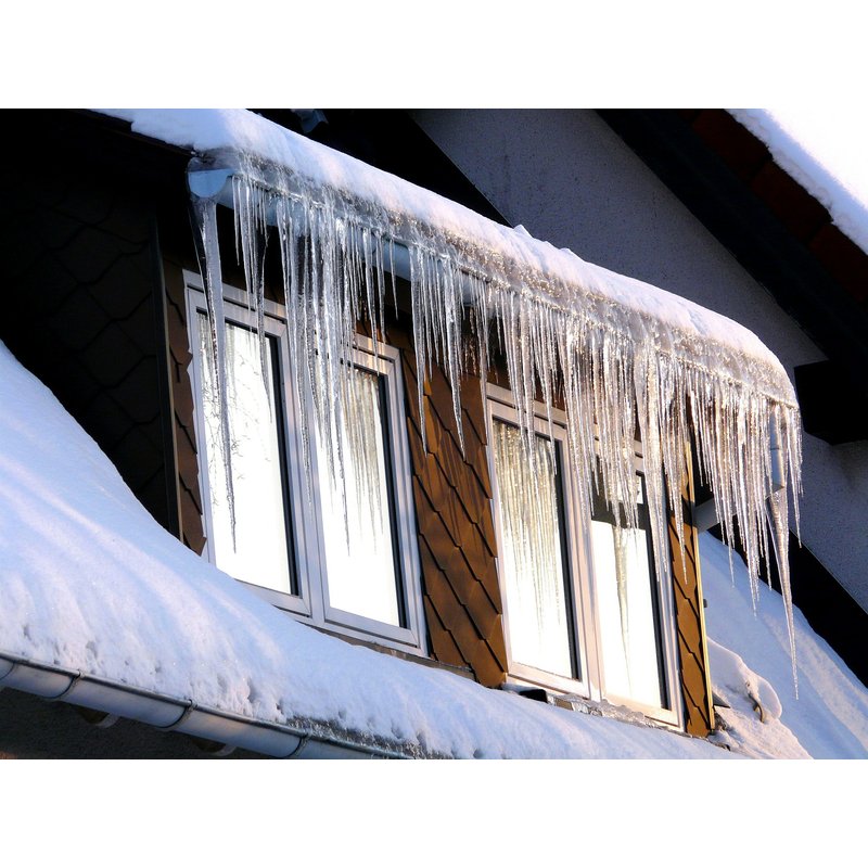 Ice dam on roof during winter