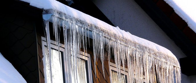 Ice dam on roof during winter