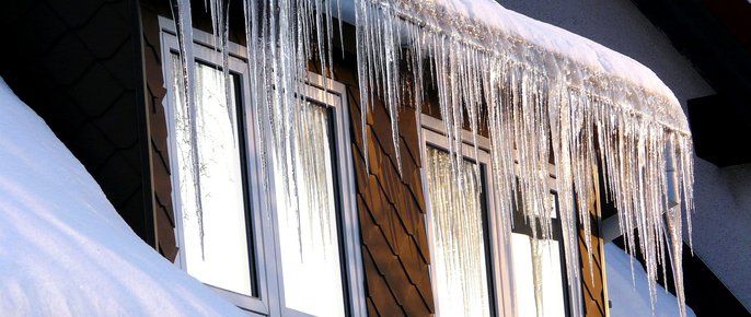 Ice dam on roof during winter