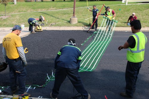 Jain Society Snow Melt Install Laying out snow melt mats