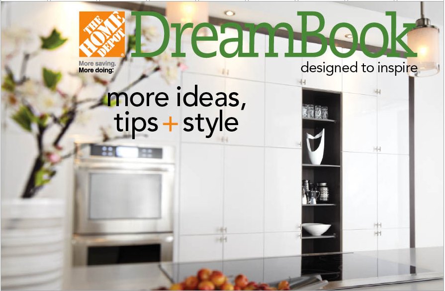 A modern kitchen interior featured in The Home Depot DreamBook with white cabinetry, stainless steel wall ovens, and an induction cooktop.