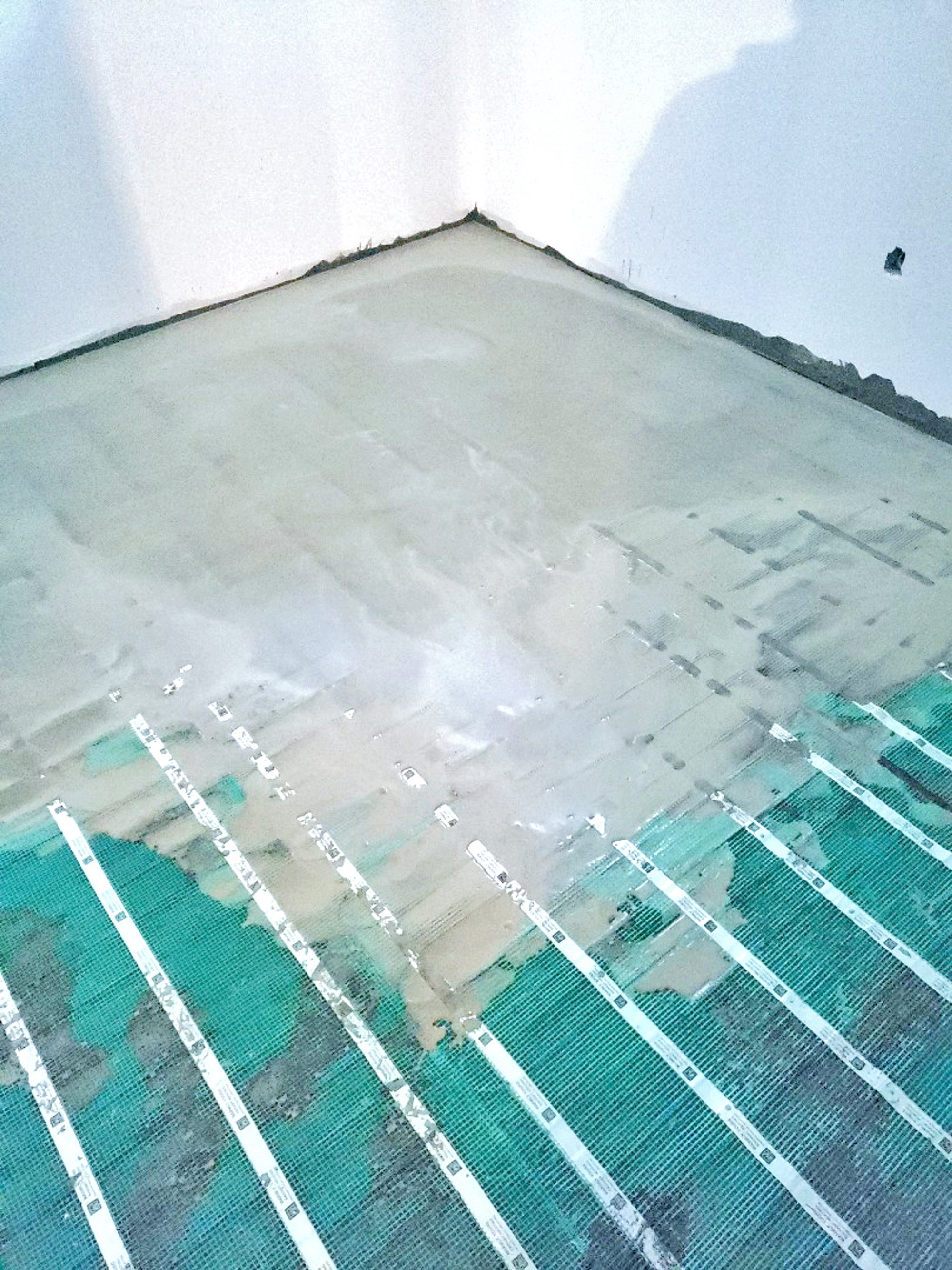 Installation of Luxury Vinyl Tile for Heated Basement Bedroom self leveling cement layer