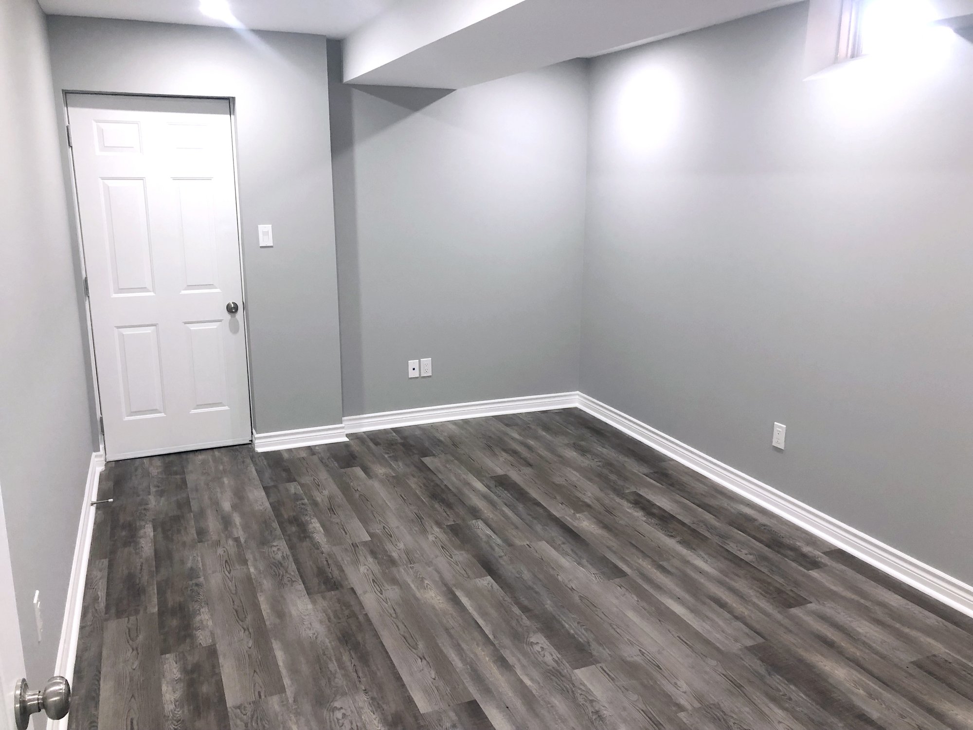 Installation of Luxury Vinyl Tile for Heated Basement Bedroom after install before furniture