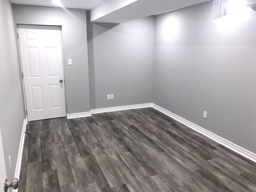 Installation of Luxury Vinyl Tile for Heated Basement Bedroom after install before furniture