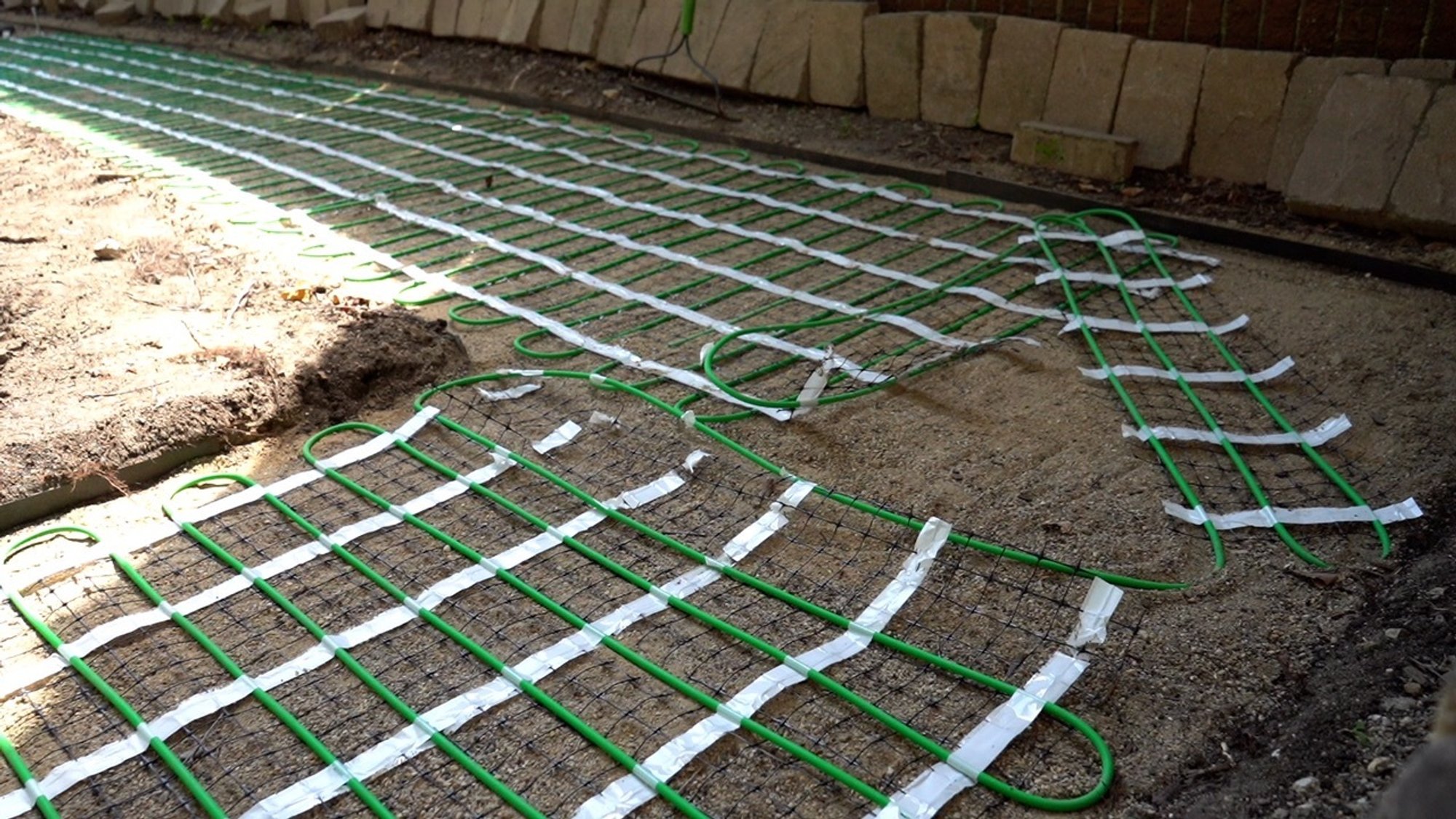 Installation of snow melt system under pavers on walkway corner EVANSTON, IL