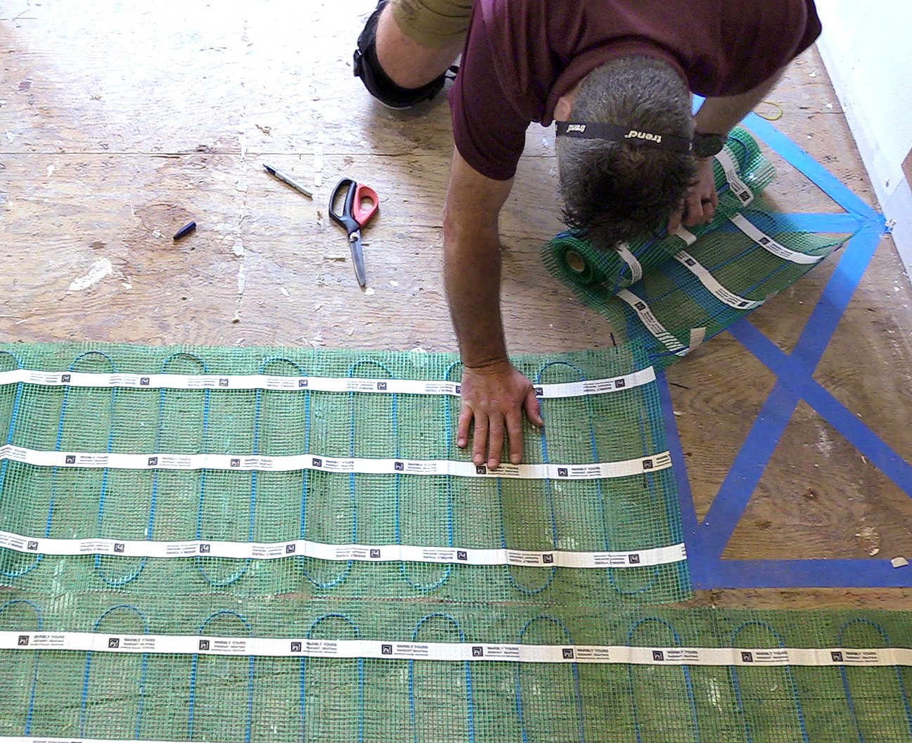 Radiant floor heating system being installed in a bathroom
