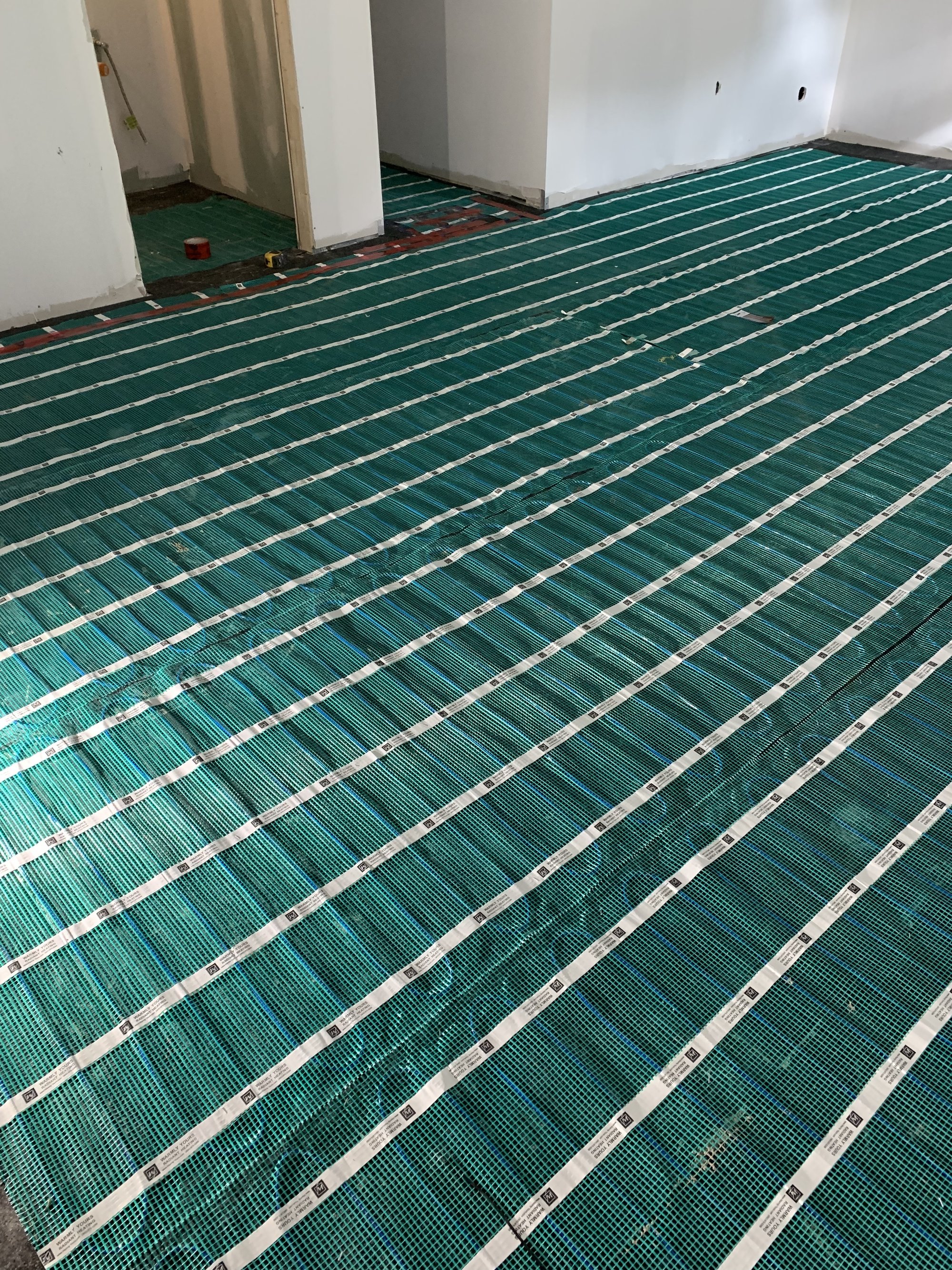 Installing Luxury Vinyl Tile for Heated Basement Playroom dry fitting heating rolls
