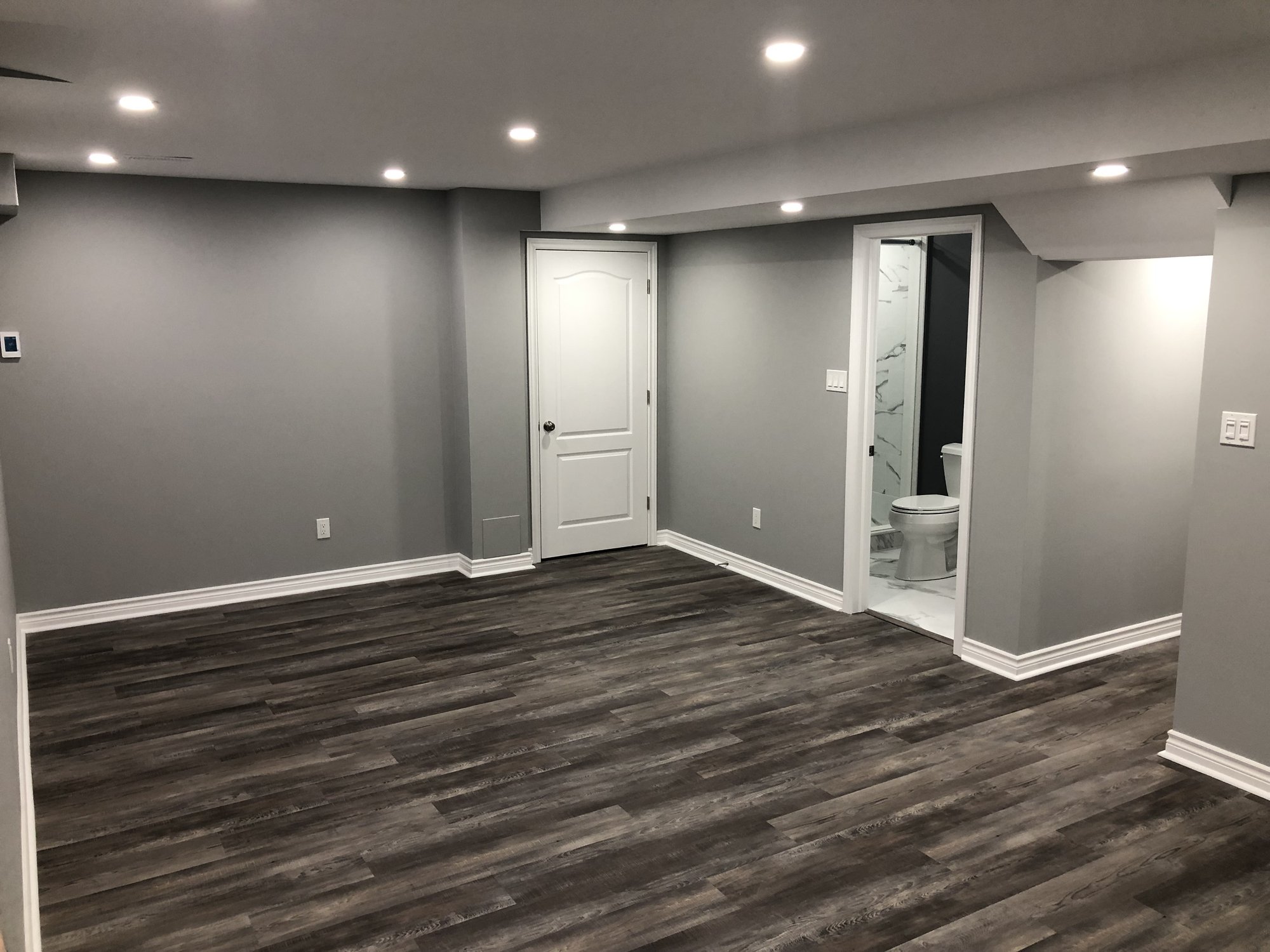 Installing Luxury Vinyl Tile for Heated Basement Playroom near bathroom