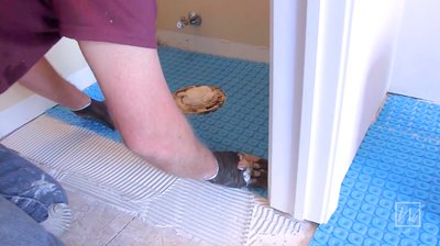 Installing Prodeso Uncoupling Membrane for bathroom floor heating