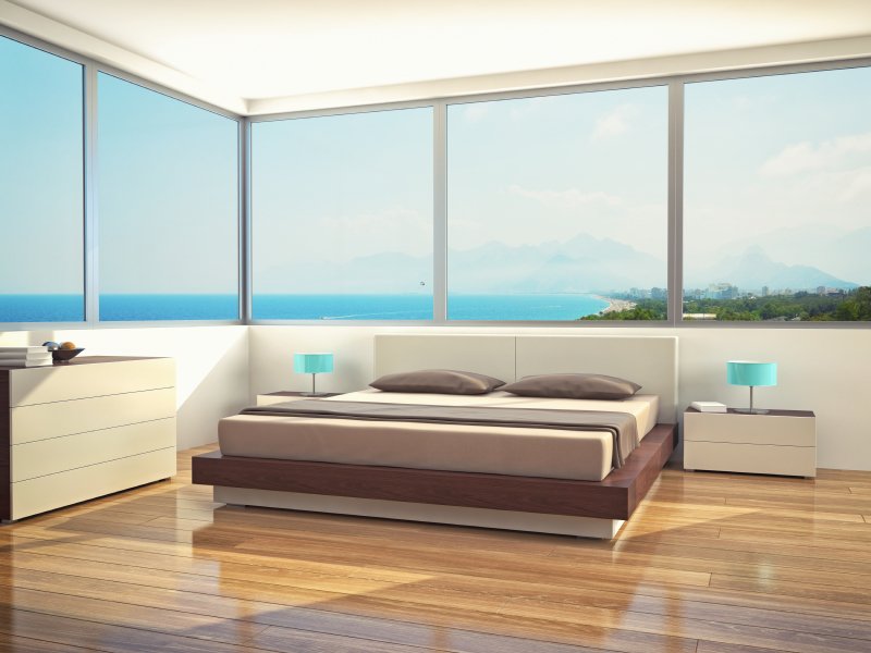 Luxurious hardwood flooring with radiant heat enhances a bedroom almost as much as the view