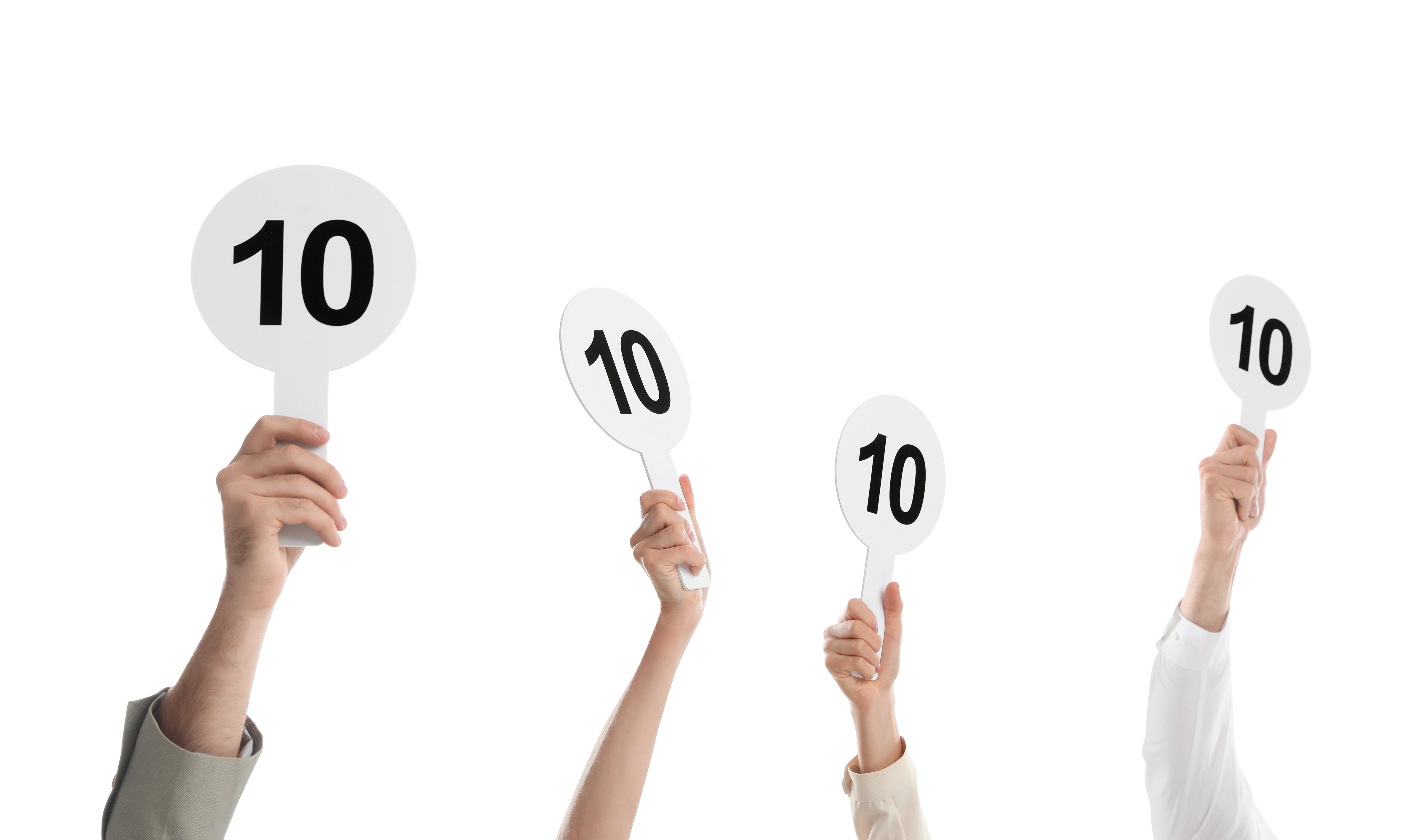 Four hands holding white scorecards each displaying the number 10.