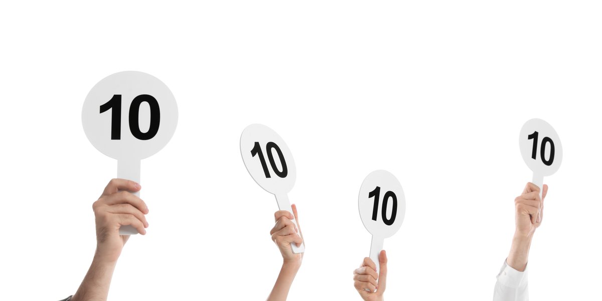 judges hold score cards showing 10