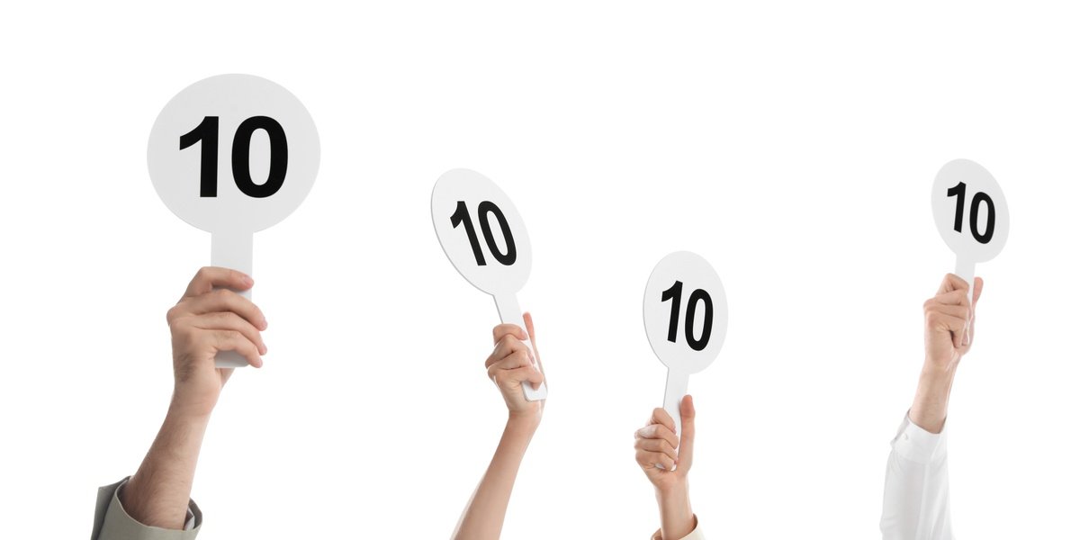 judges hold score cards showing 10