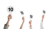 judges hold score cards showing 10