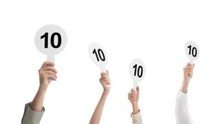 judges hold score cards showing 10