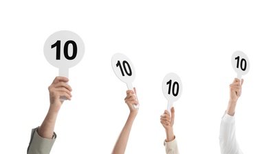 judges hold score cards showing 10