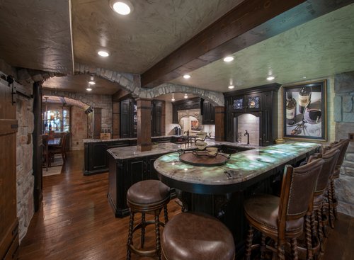 Kitchen and bar with heated wood floors by Architectural Justice