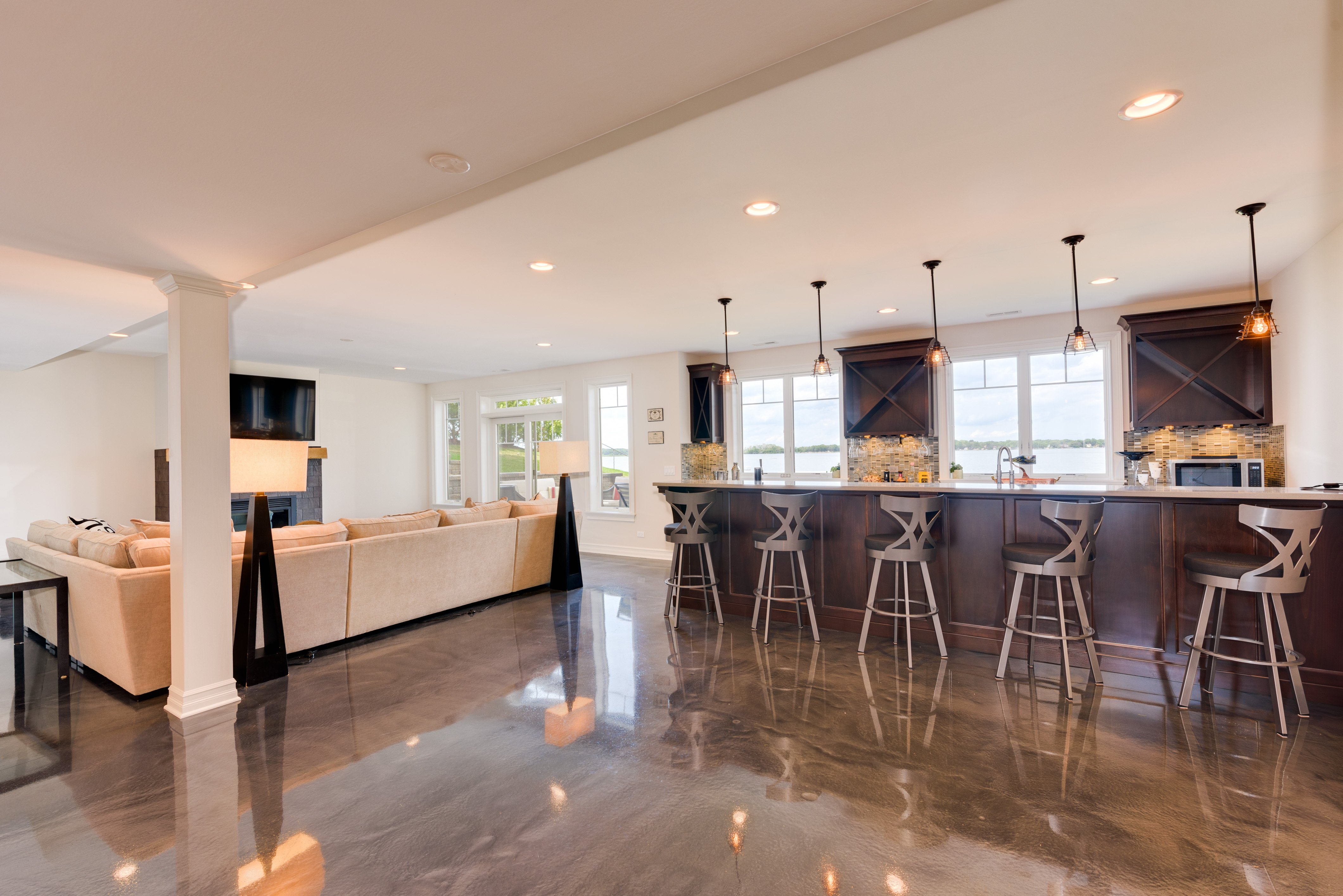 Heated polished concrete floor in a modern basement, view looking towards bar. Countertop Heaters