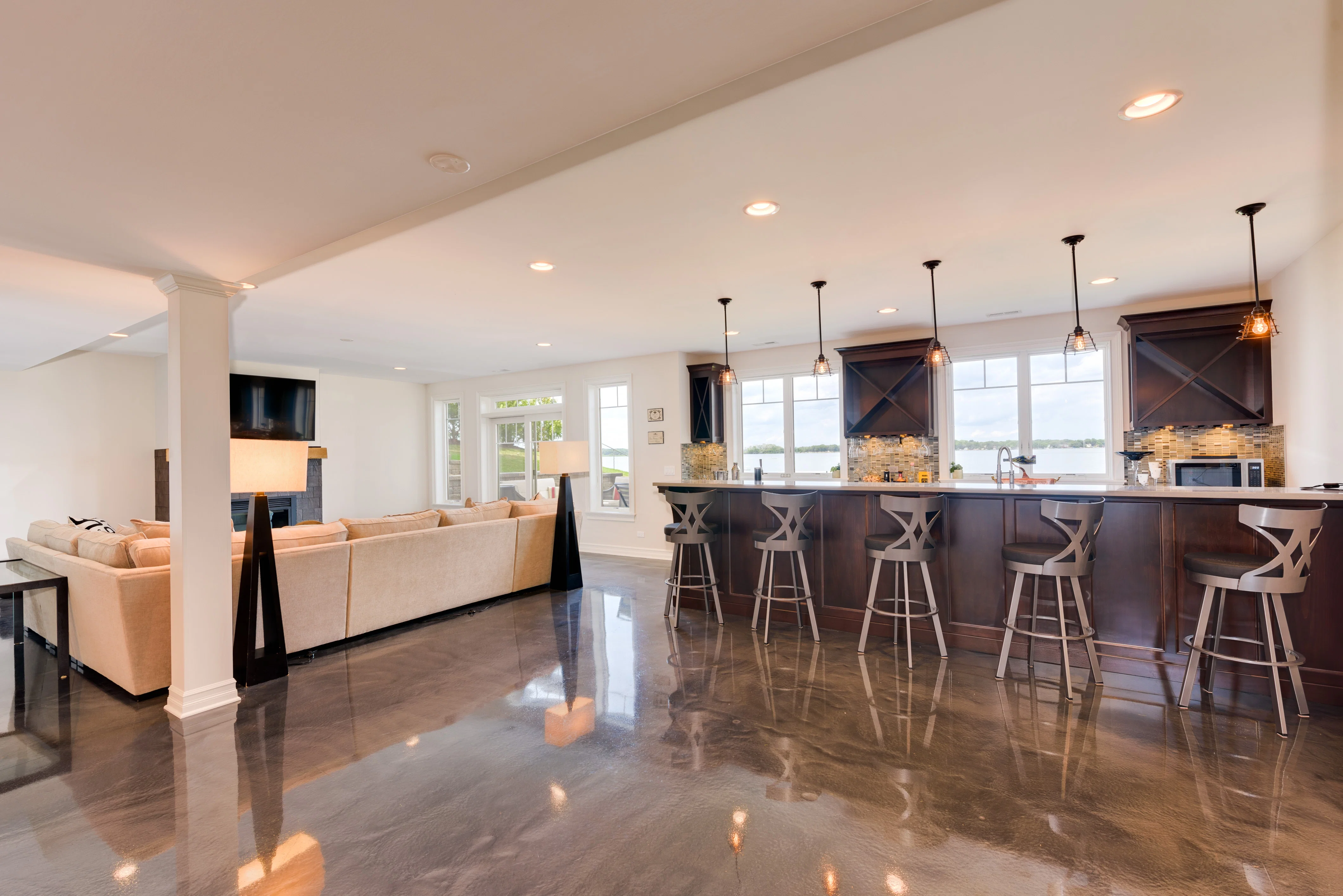 Heated polished concrete floor in a modern basement, view looking towards bar. Countertop Heaters