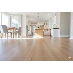 A bright open-concept kitchen and dining area featuring light-colored wood-look laminate flooring throughout the space.