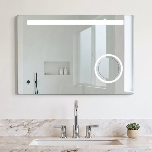 A Judy LED backlit rectangular bathroom mirror with a horizontal light bar and magnifying section mounted above a marble vanity.