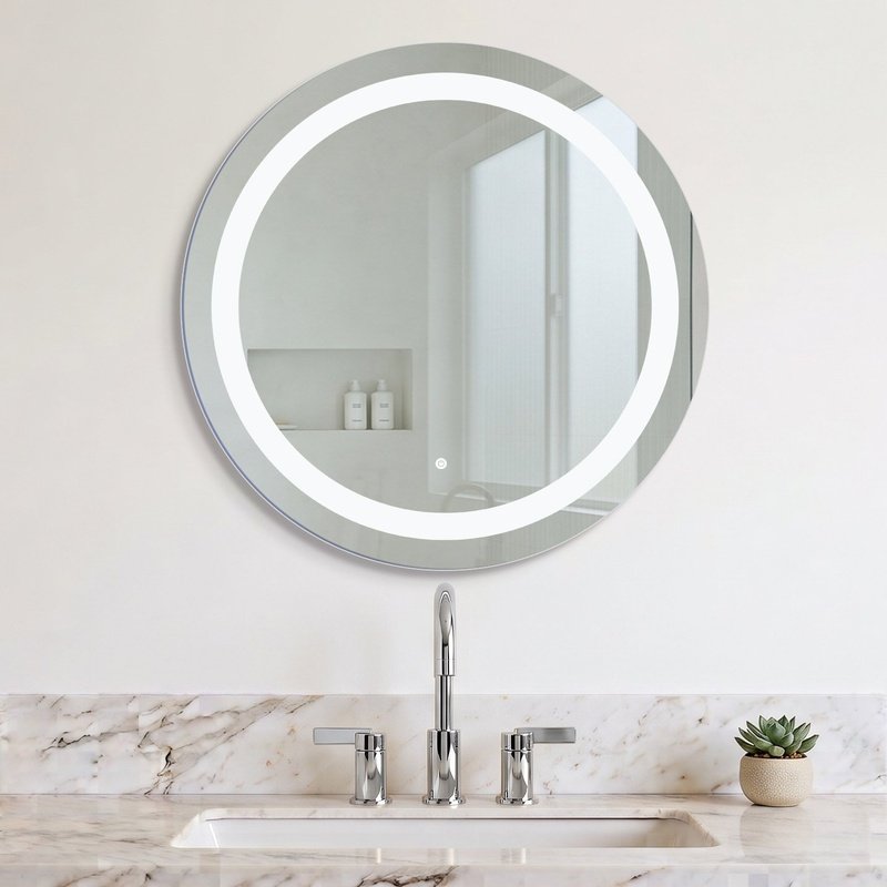 Marilyn round LED illuminated bathroom mirror with a frosted light band mounted above a marble vanity with a brushed brass faucet.