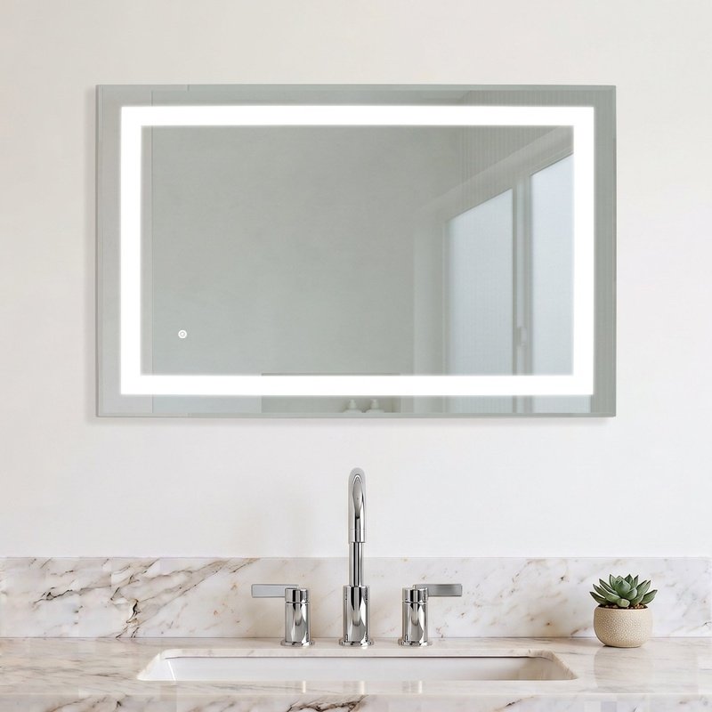 Audrey LED backlit rectangular mirror with a frosted border and ambient lighting mounted on a marble bathroom wall above a vanity.
