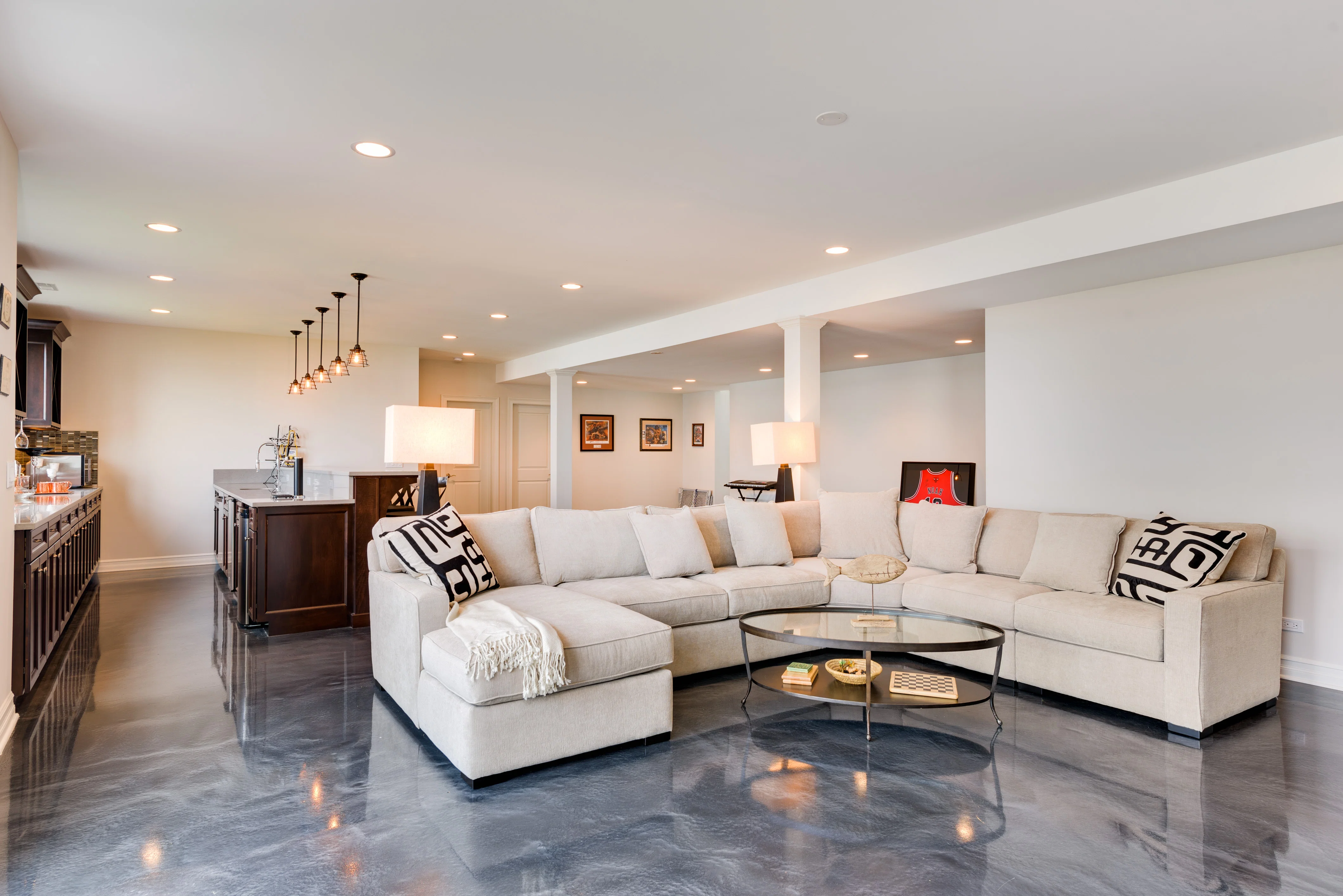 Living room and bar area in a modern basement with heated concrete floors. Radiant Heat Underlayment