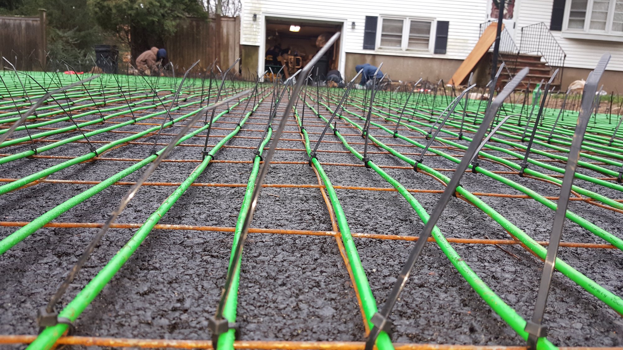 Lotacki Snow Melt Cable Installation 1 close up of snow melt cable zip tied to metal grid