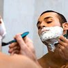 Man using mirror to shave