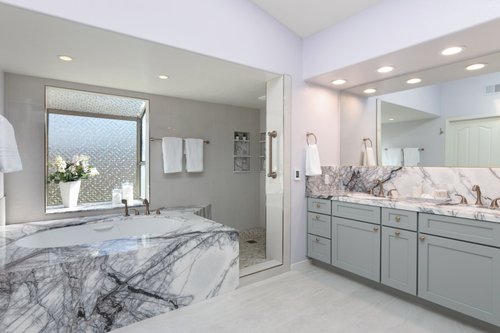 Marble master bath with electric floor heating angled shot with tub Landers project