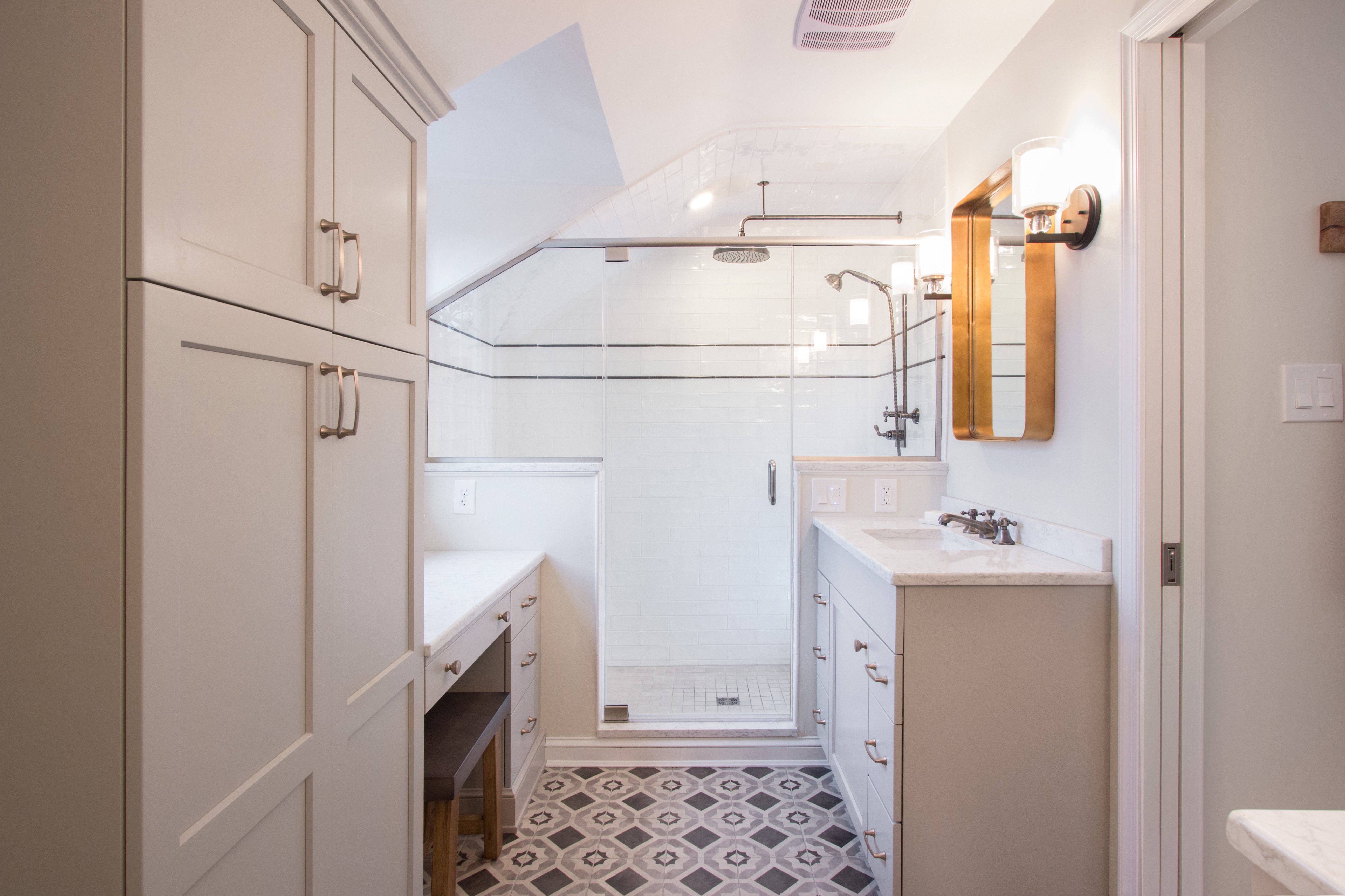Long bathroom view showcasing heated stone tiles leading to a modern walk-in shower