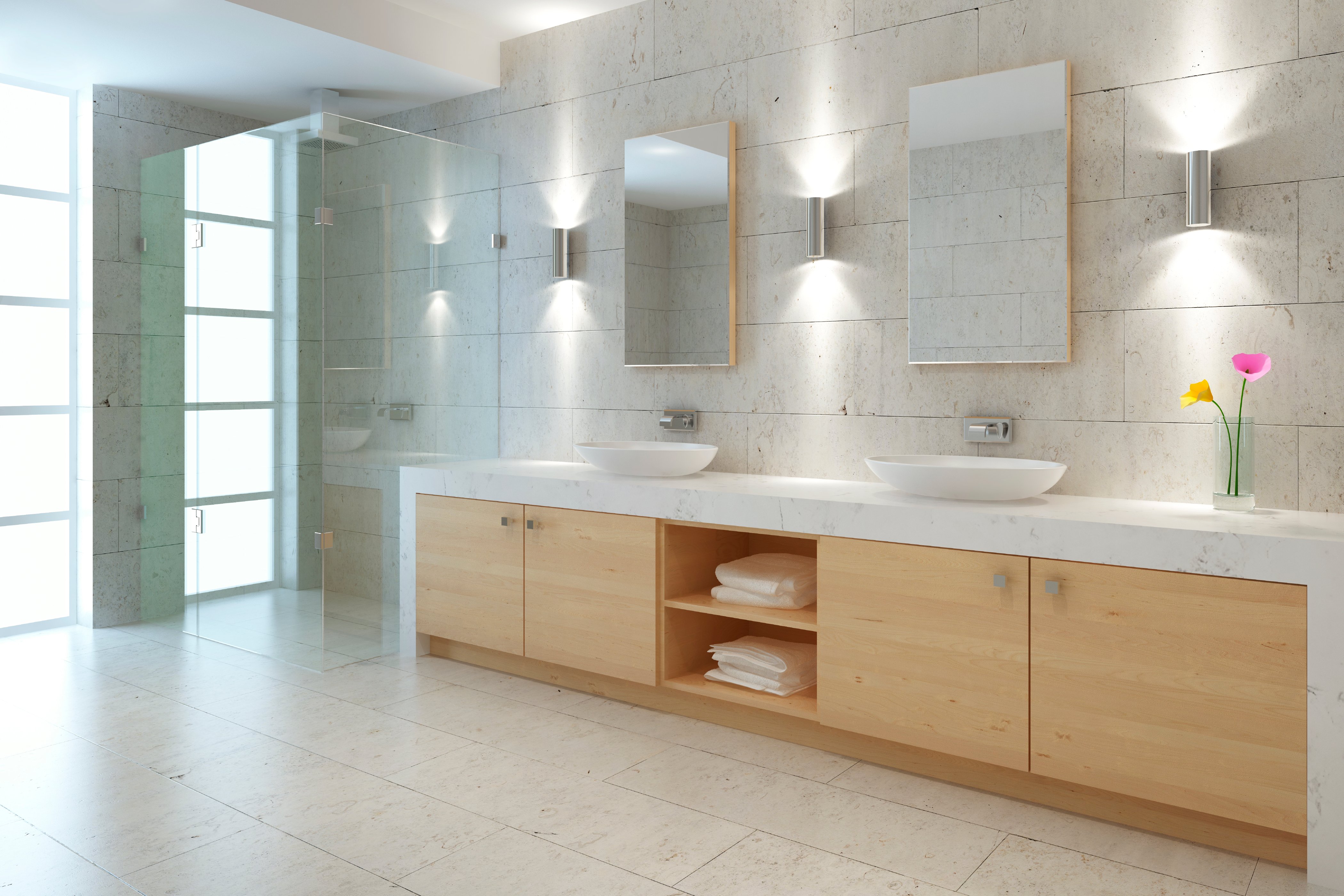 A modern bathroom with light stone tile flooring suitable for an electric radiant floor heating system installation.
