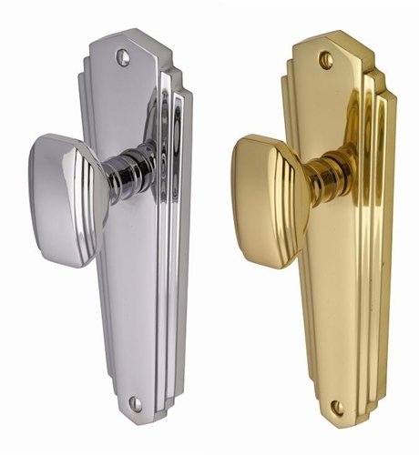 Two Art Deco style doorknobs with fluted oval knobs and stepped skyscraper backplates in polished chrome and polished brass finishes.