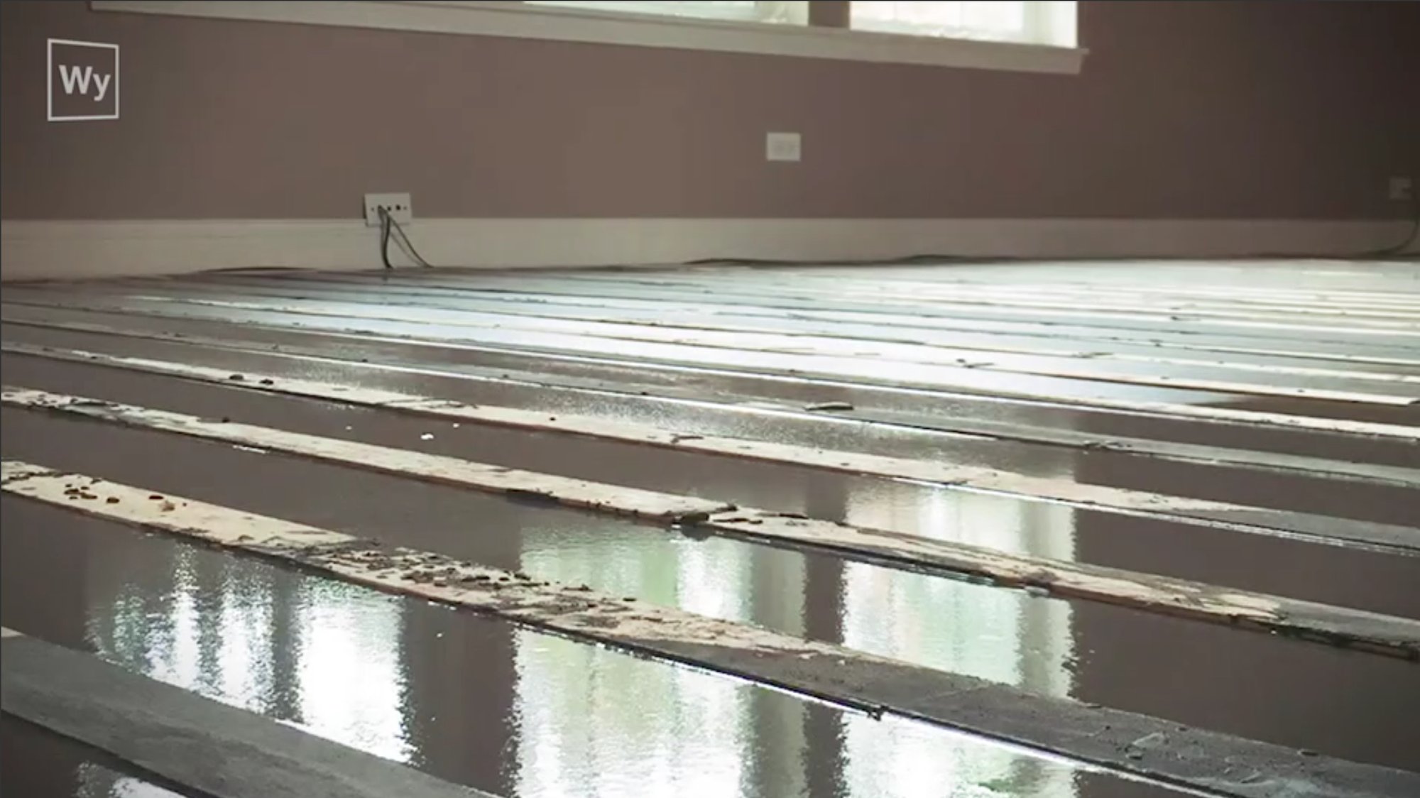 Nailed hardwood floor installation self leveling cement layer