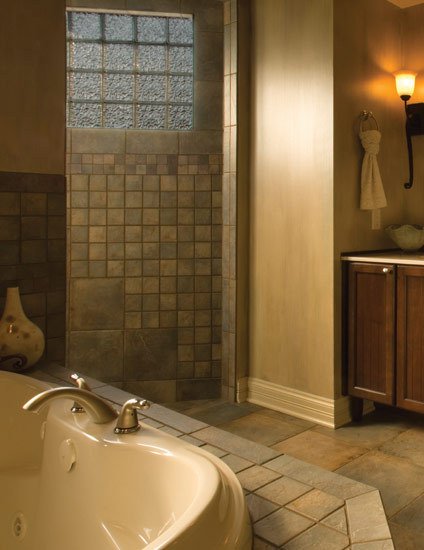 A bathroom with slate tile flooring installed over an electric radiant floor heating system.