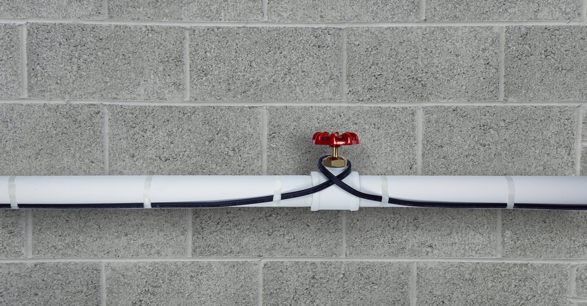 Pipe freeze protection heating cable installed on plastic pipe