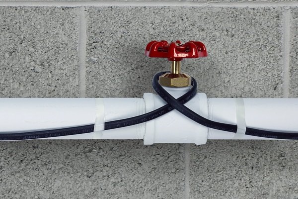 Pipe freeze protection heating cable installed on plastic pipe close
